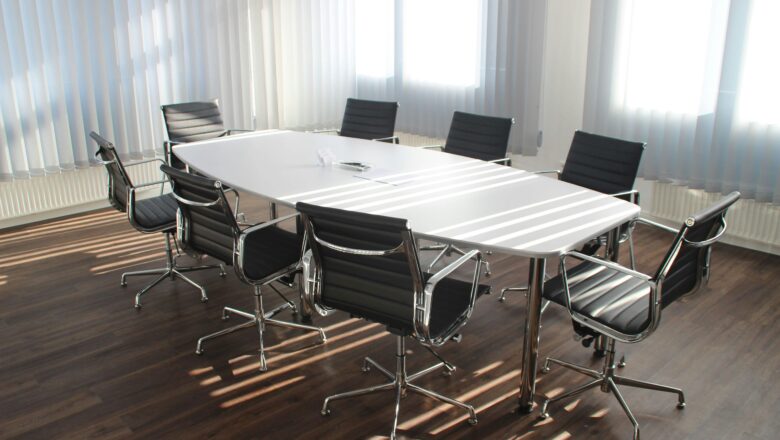 Empty boardroom table with chairs